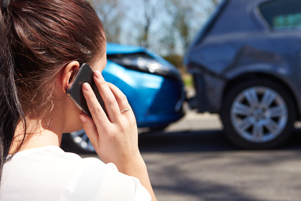 woman on the phone at a car accident